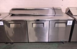 True TSSU-72-18-HC stainless steel 3 door refrigerator and food preparation area