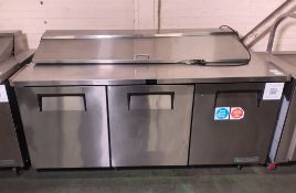 True TSSU-72-18-HC stainless steel 3 door refrigerator and food preparation area