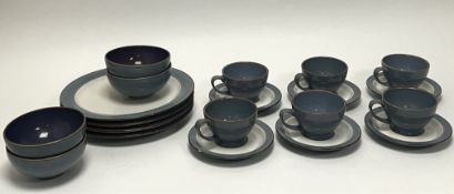 A collection of Denby stoneware in a blue/grey mottled colourway comprising six teacups and saucers,