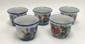 A collection of five Highland Stoneware plant pots, each decorated with poppies and thistles, with