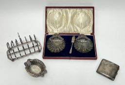 A collection of silver to include a pair of Birmingham silver shell butter dishes on three ball
