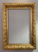 A late 19th century Art Nouveau style giltwood picture frame, with stylized scrolling leaf