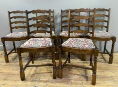 A set of six Ercol-style dining chairs, ladder backs over floral upholstered drop-in seats, raised