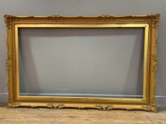 A Victorian-style giltwood picture frame: Opening H. 65cm L. 115cm