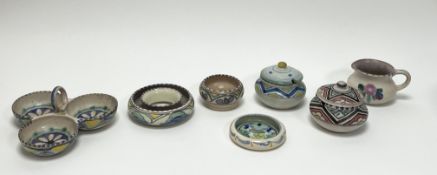 A collection of Honiton earthenware dishes all decorated with geometric and foliate designs