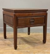 A modern Chinese cherry wood lamp table, square top over single drawer with carved handle, on square