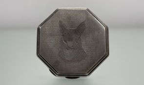 A vintage Sterling silver octagonal compact with engine turned decoration and portrait of a dog:
