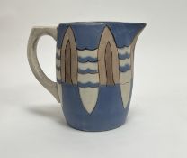 A studio pottery jug with geometric surfboard and wave design on a blue ground, marked