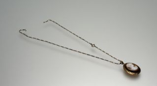 A 9ct gold oval shell carved cameo portrait pendant on flat link chain necklace - note chain broken: