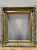 A reproduction Victorian-style giltwood picture frame: Opening H. 54cm L. 44cm