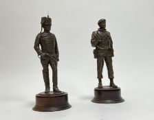 A cast resin bronzed military British soldier sculpture by Peter Hicks raised on a wooden circular