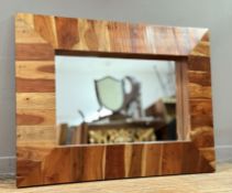 A rectangular hall mirror in rustic style, with a stainted striped wooden frame, with central
