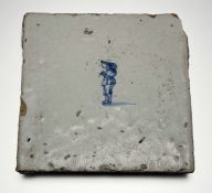 A late 18th/ 19thc Dutch Delft pottery square tile with single figure in traditional dress: h/w. x