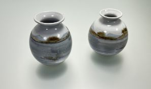 A pair of Highland Stoneware vases of squat form, both decorated with hand-painted loch and hill