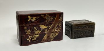 A Japanese style lacquer table top cabinet, decorated with gilt birds and cherry blossom on a