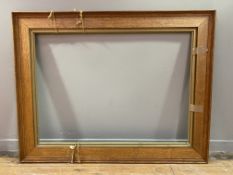 A Victorian oak picture frame with moulded edge and gold inner trim: Opening H. 77cm L. 107cm