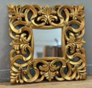 A decorative gilt painted wooden hall mirror, with scrolling foliate frame with central mirror