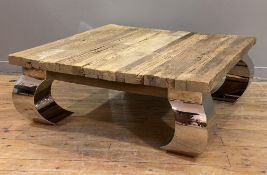 A contemporary hardwood coffee table, square plank top raised on curved polished steel supports: