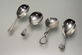 A collection of four silver loose tea caddy spoons to include an Edwardain Sheffield silver rat tail