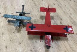 Two contemporary model hanging aeroplanes, one wooden and one metal, with chains to attach to