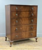 A reproduction mahogany chest of drawers, moulded top over five graduated drawers to front, raised