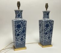 A pair of 1960s blue and white table lamps of shouldered form, raised on square brass bases,