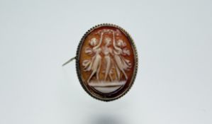 A 9ct gold oval shell carved cameo brooch/pendant depicting the three graces in rub over setting