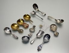 A collection of four vintage brass caddy spoons, a collection of eight epns caddy spoons, an