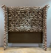 A contemporary bespoke wing-back headboard, with button-back and upholstered in brown and cream