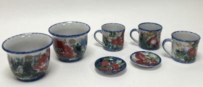 A collection of Highland Stoneware handpainted with poppies and thistles amongst foliage