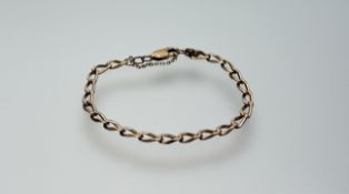 A 9ct gold kerb link chain bracelet with lobster claw fastening anad safety chain: d. x 8cm 7.53g