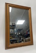 A contemporary mirror with wooden stepped frame (h. 75.5cm
