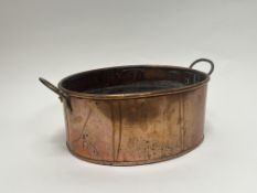 A copper planter of oval form, with twin brass handles (l. 39.5cm)