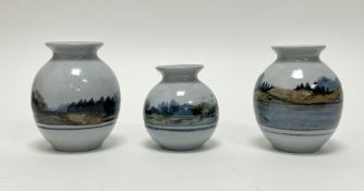 A collection of three Highland Stoneware bud vases, each decorated with Scottish landscape scenes (