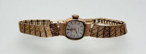 A vintage 9ct gold Rotary manual wind wristwatch with silvered dial and baton hour markers on