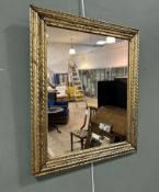 A gilt framed mirror featuring stepped mouldings with repeating beaded and reeded detailing (h. 52cm