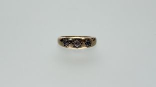 A late 19thc 18ct gold ring set three graduated old mine cut diamonds in star setting centre stone