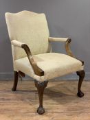 A reproduction mahogany Gainsborough chair, shaped top and open arms upholstered in soft yellow