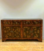 A Chinese pine lacquered chest, fitted four short drawers and two pairs of panel doors, with allover