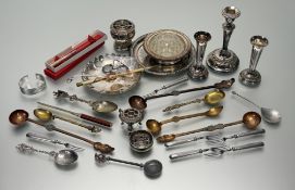 A box containing a collection of two white metal continental spoons with a masted galleon and a pair