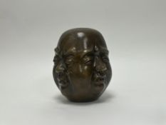 A 1960s Chinese bronze four-faced Buddha head symbolising the four phases of life; Joy, Anger,