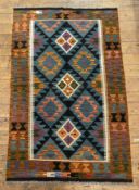 A hand-knotted Maimana kilim rug, central panel with repeating diamond-shaped motifs, navy blue