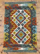 A hand-knotted kilim rug, central panel with twin diamond motifs, burnt orange ground and multi-