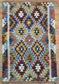 A hand-knotted Chobi kilim rug, central panel with diamond motifs on a multi-coloured ground: L.