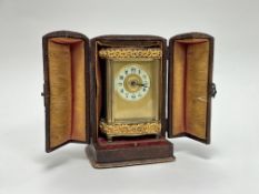 A decorative French R & Co carriage clock with rococo style foliate case mounts, with key and