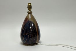 A studio pottery table lamp of bulbous form, decorated with glazed flowers and asymetric forms to