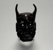 An early 20thc Japanese patinated cast bronze Hannya Kabuki mask. (h-11cm l-7cm w-4.5cm)