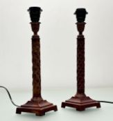 A pair of cast metal neo-classical style painted column table lamps, both raised on raised squared