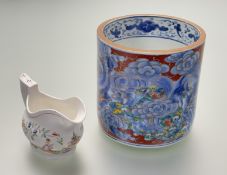 A 19thc Japanese blue and white overpainted brush pot, depicting dragon chasing the pearl, with