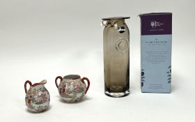A Japanese Kutani syle milk jug and sugar bowl decorated with enamelled figural scenes against a